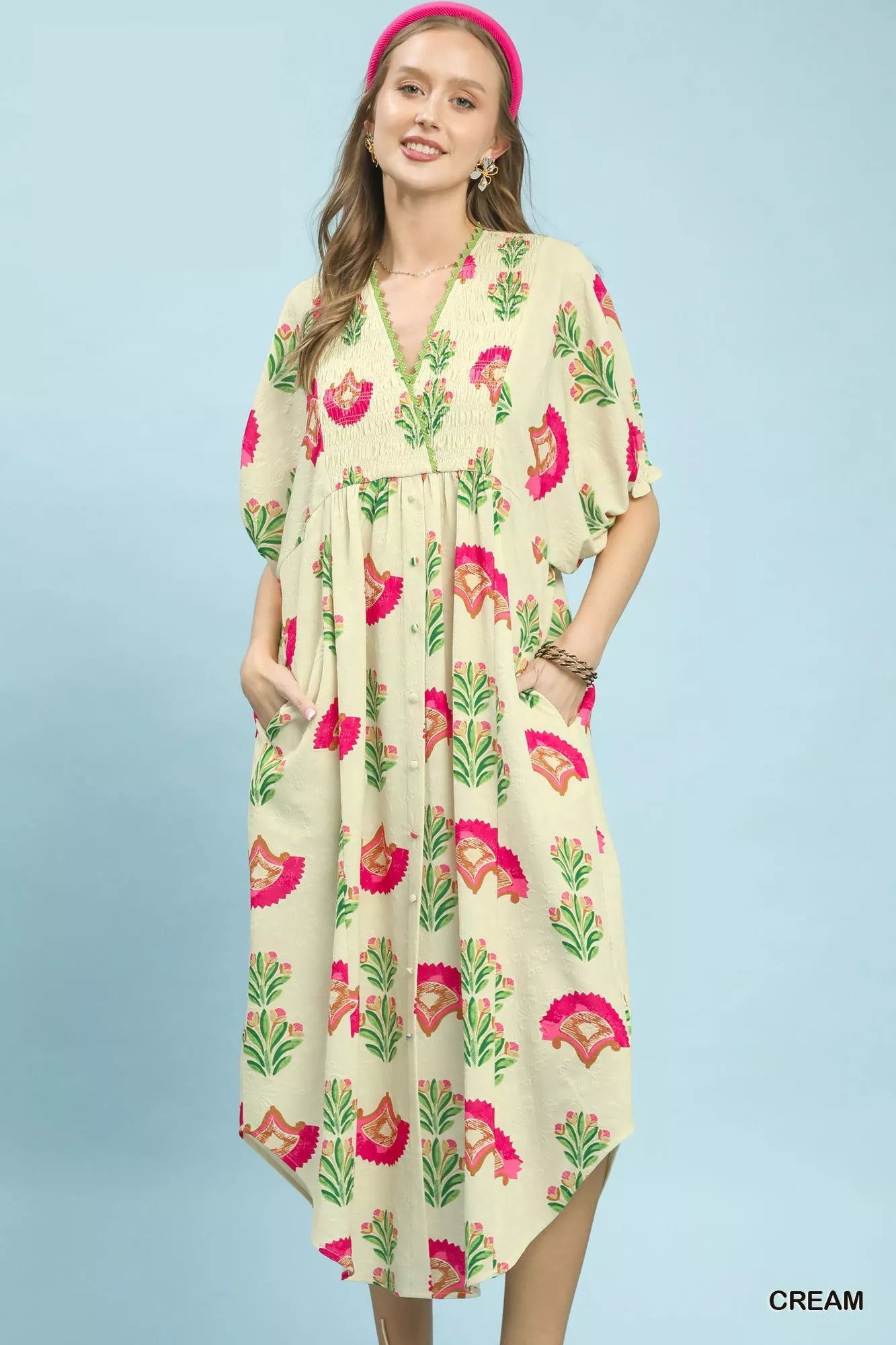 Woman wearing a floral dress with a pink background