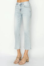 Light blue jeans worn by a person on a white background