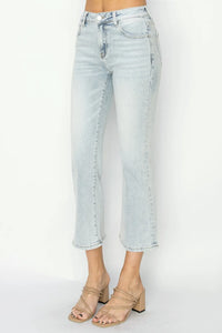 Light blue jeans worn by a person on a white background