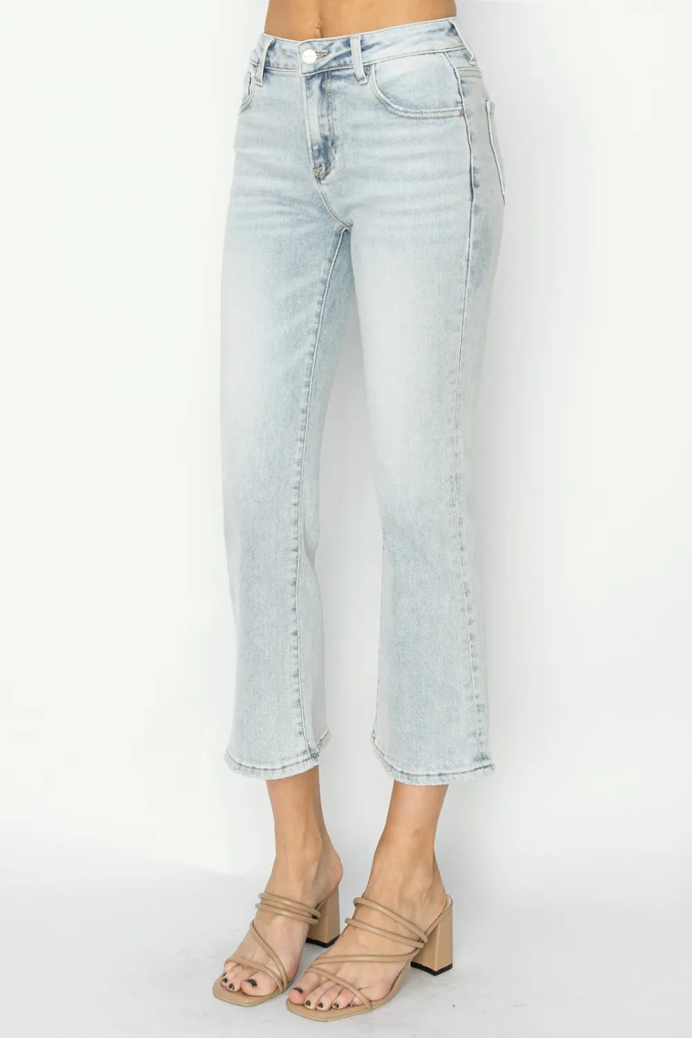 Light blue jeans worn by a person on a white background