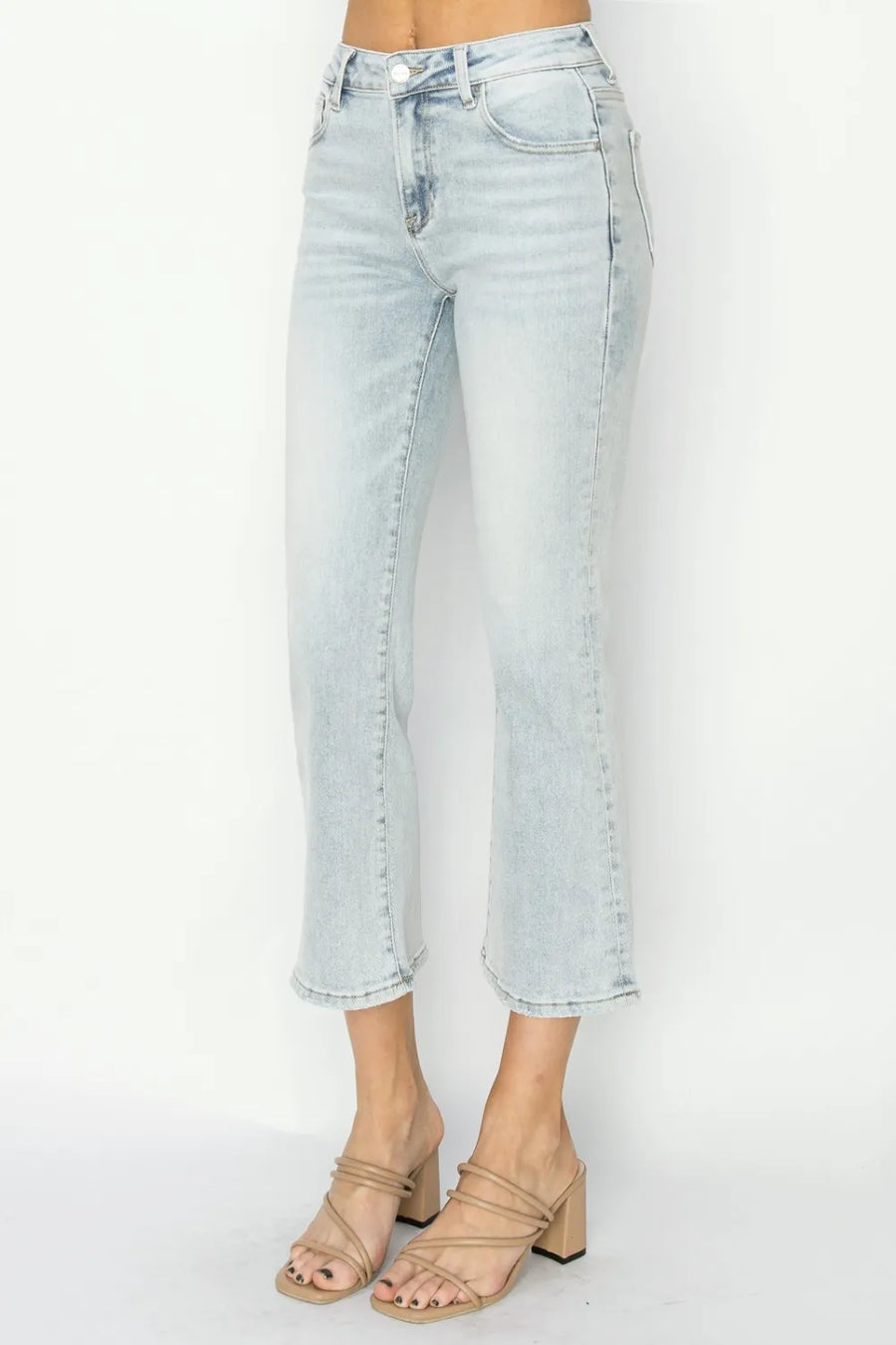 Light blue jeans worn by a person on a white background