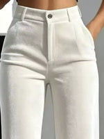 White high-waisted cropped pants with a structured waistband, front pleats, and a single button closure, shown on a model cropped from the waist down.