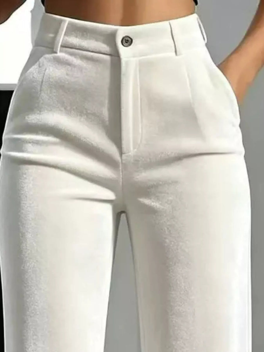 White high-waisted cropped pants with a structured waistband, front pleats, and a single button closure, shown on a model cropped from the waist down.