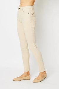 Beige pants worn by a person on a white background