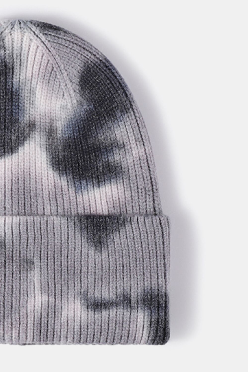 Gray knit beanie with tie-dye pattern on a white background