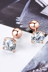 Rose gold stud earrings with clear gemstones on a light background