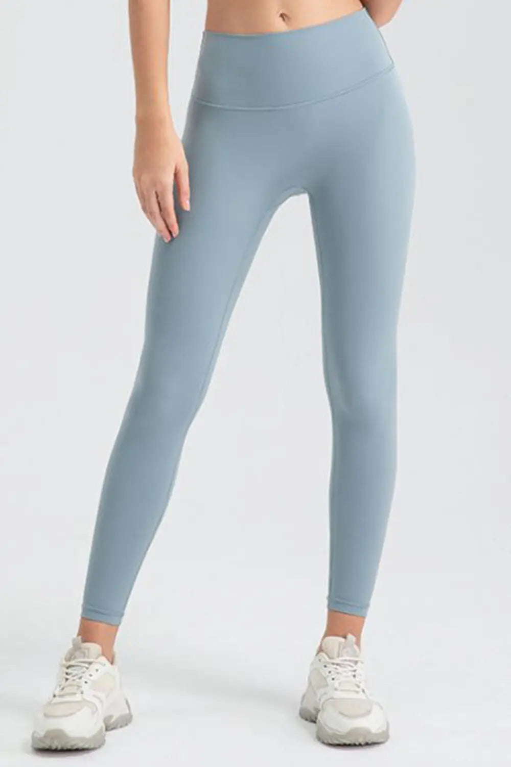 Light blue leggings worn by a person on a white background