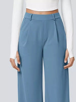 Blue pants worn by a person on a plain background