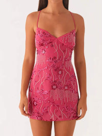 Pink dress with floral and bead details on a white background