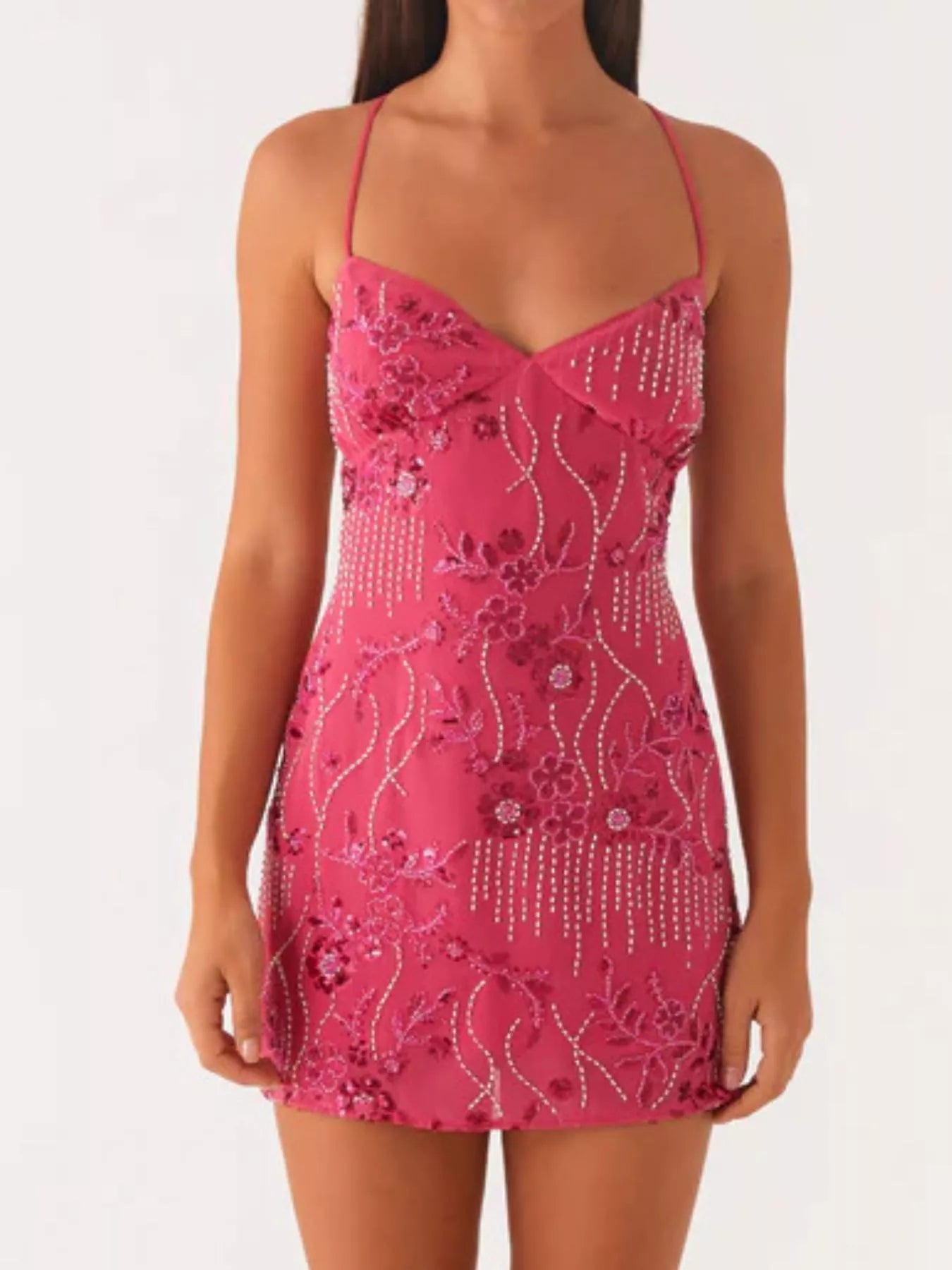 Pink dress with floral and bead details on a white background