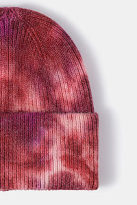 Close-up of a red and pink patterned beanie on a white background