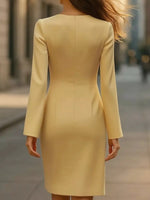 Yellow dress worn by a person on a blurred street background
