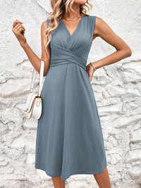 Woman wearing a blue dress against a stone wall