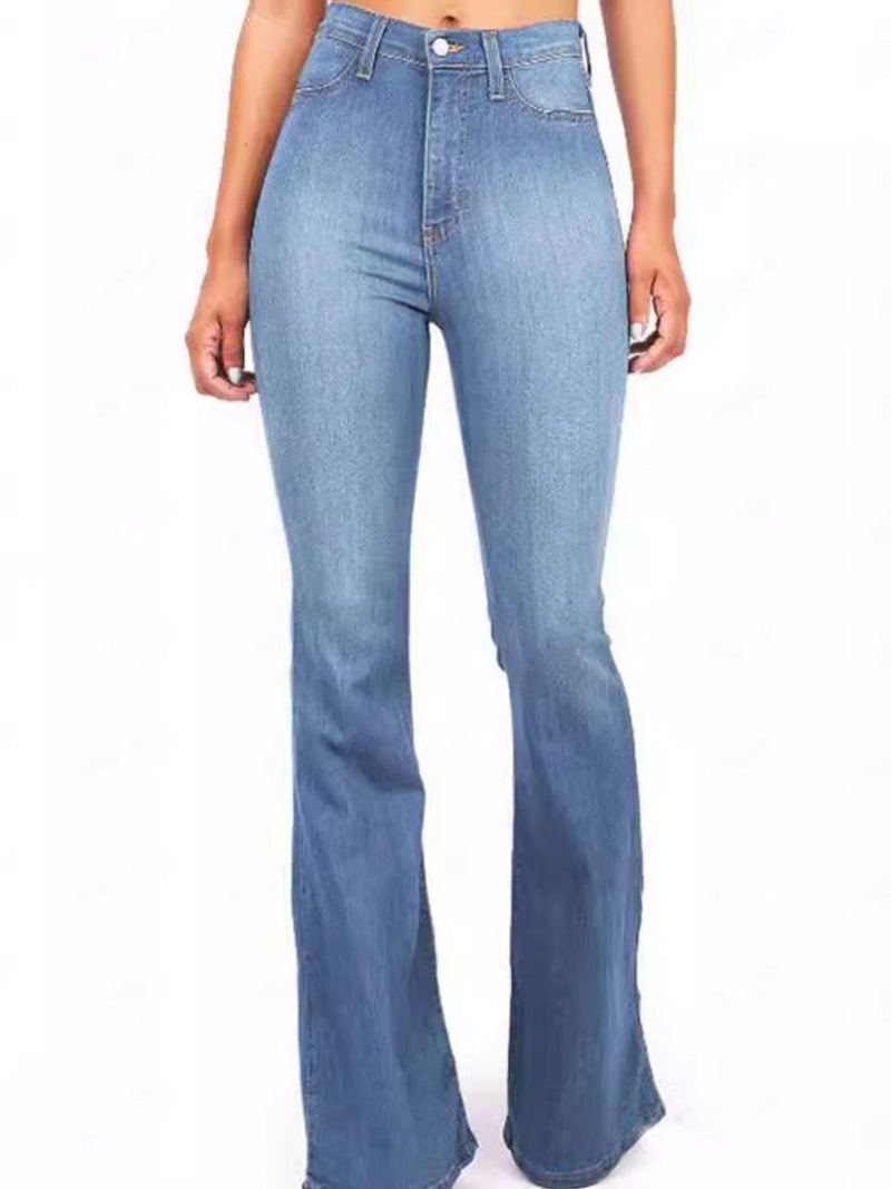 Blue flared jeans worn by a person on a white background