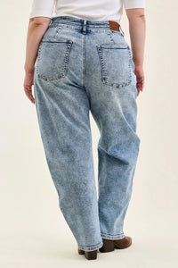 Person wearing light blue jeans on a white background