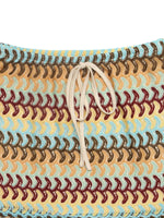 Multicolored woven bag with a drawstring on a white background