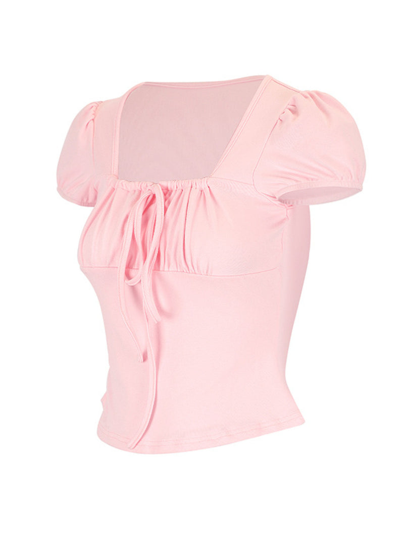 Pink top with puff sleeves on a white background