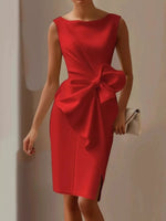 Red dress with a large bow detail on a plain background