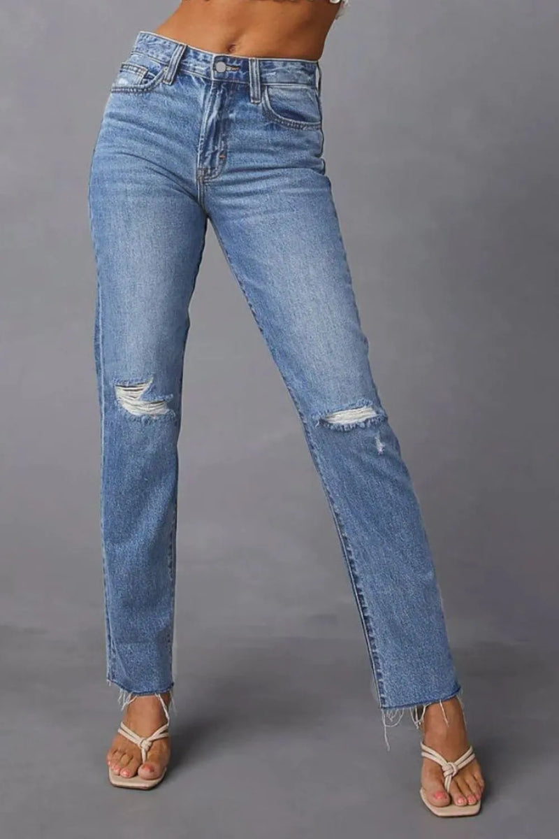 Blue jeans with slight distressing on a gray background