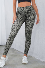 Person wearing gray leopard print leggings against a plain background