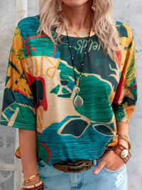Person wearing a colorful graphic t-shirt with abstract designs.