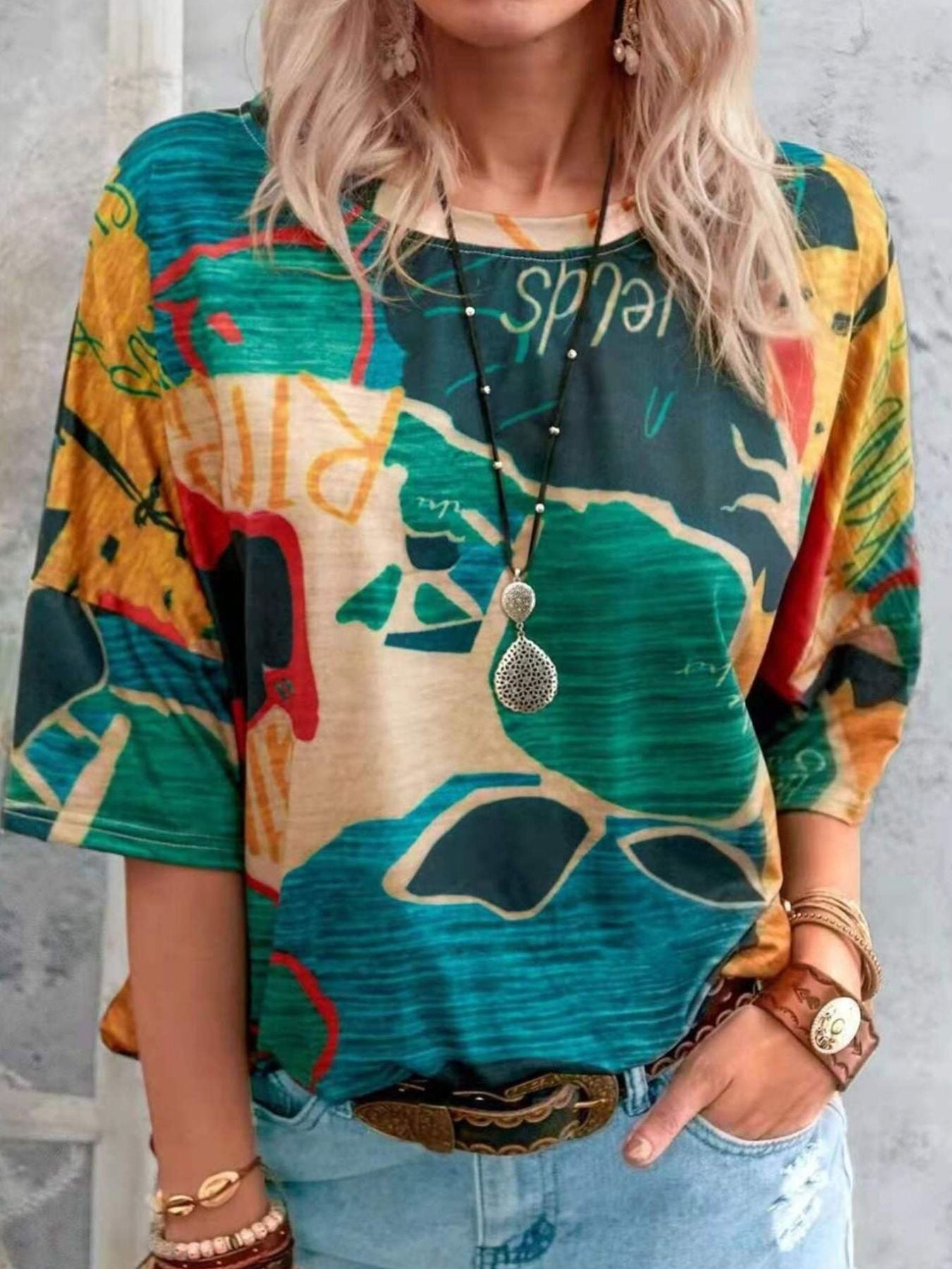 Person wearing a colorful graphic t-shirt with abstract designs.