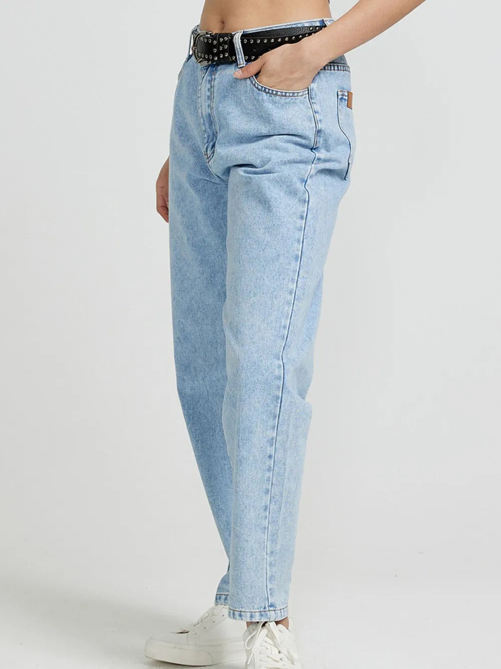 Light blue jeans worn by a person on a white background