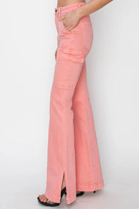 Pink flared jeans worn by a person on a white background