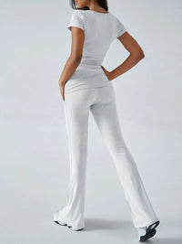 Person wearing a white outfit with a plain background