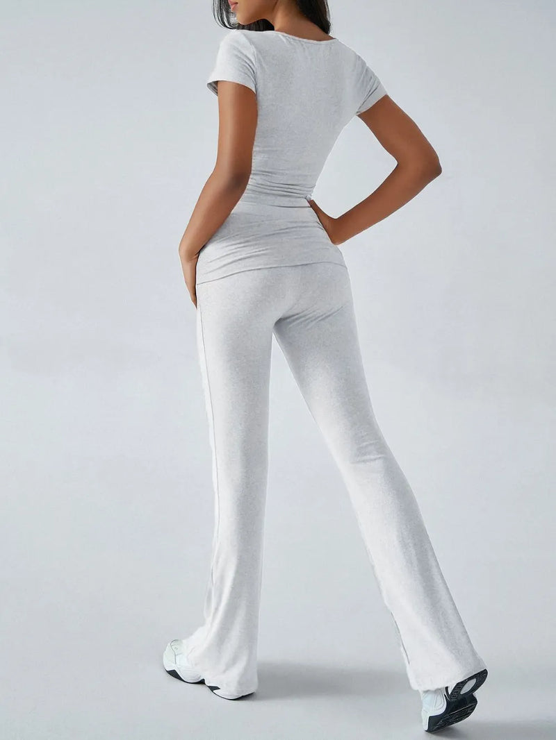 Person wearing a white outfit with a plain background
