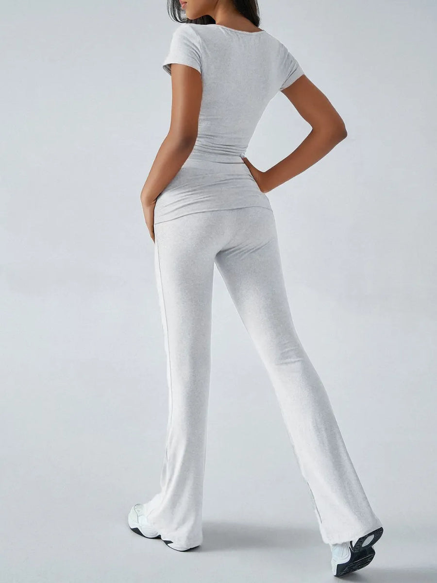 Person wearing a white outfit with a plain background
