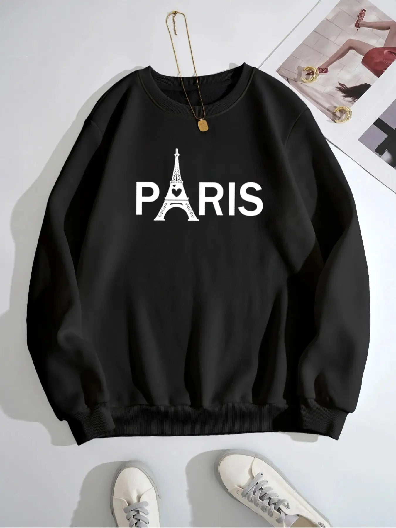 Black sweatshirt with 'PARIS' and Eiffel Tower design on a white background