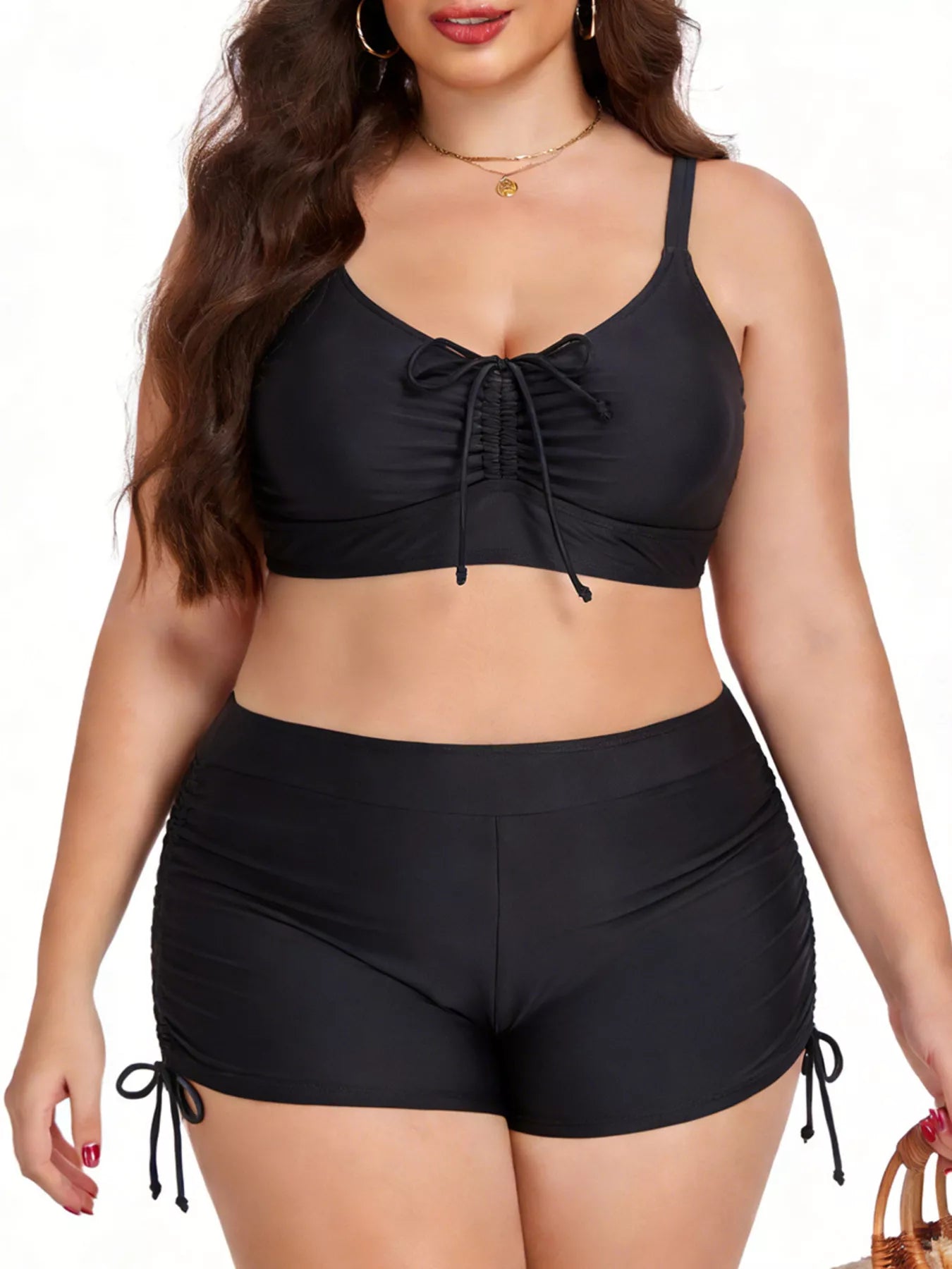 Woman wearing a black bikini set on a white background