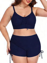 Woman wearing a navy blue bikini set on a white background