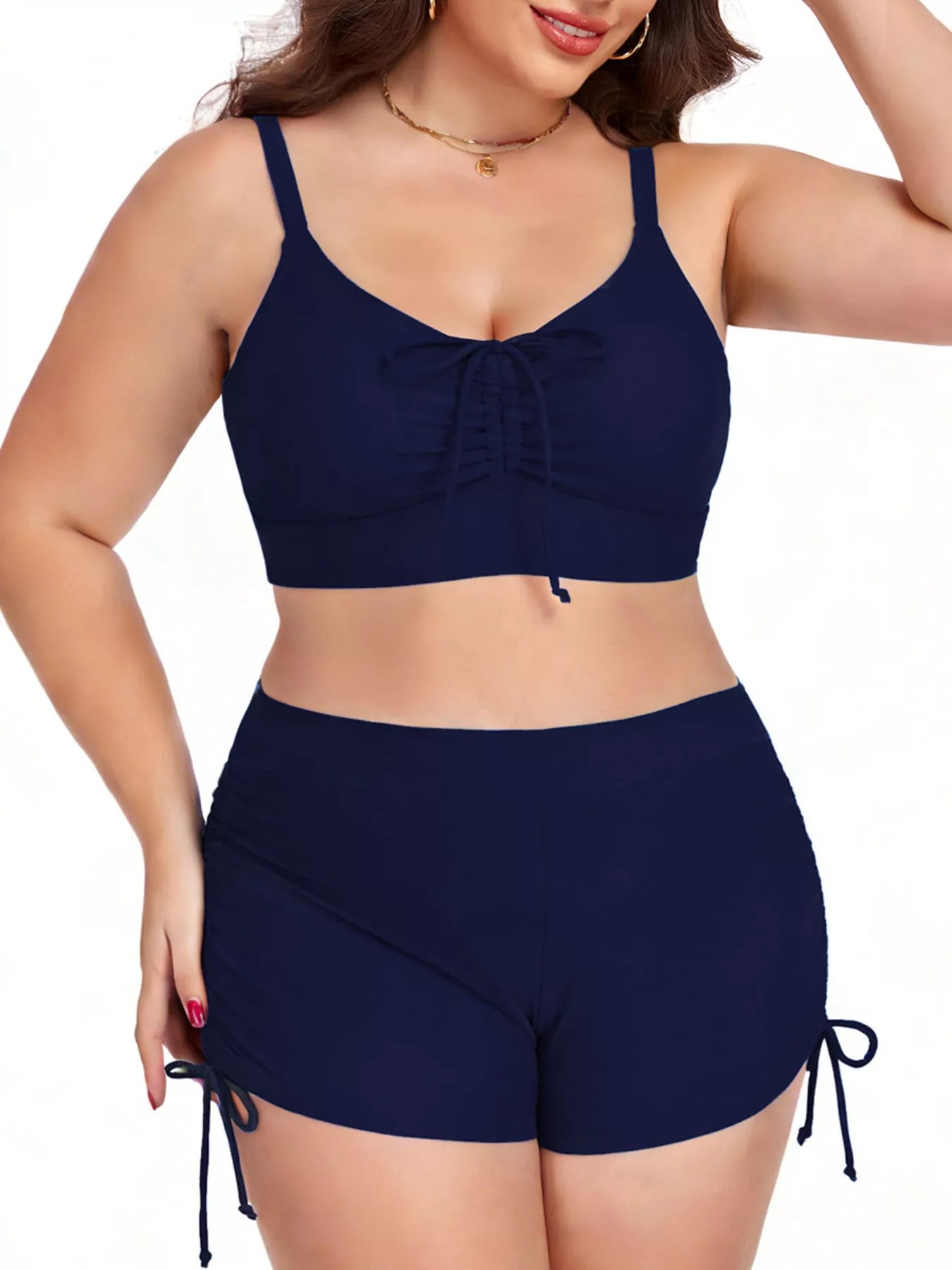 Woman wearing a navy blue bikini set on a white background