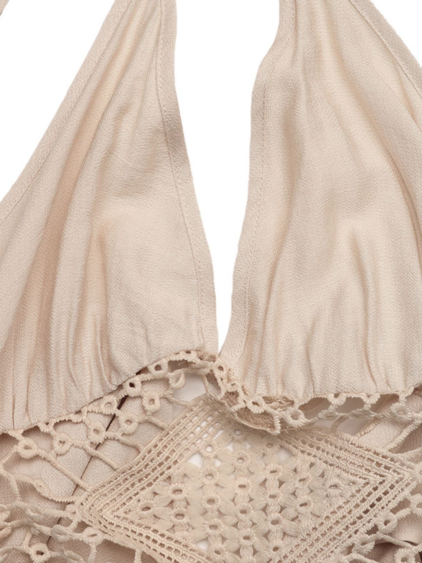 Beige bikini top with lace details on a white background