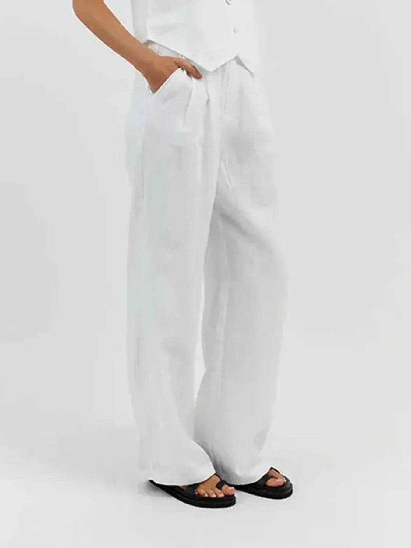 White wide-leg pants worn by a person on a white background