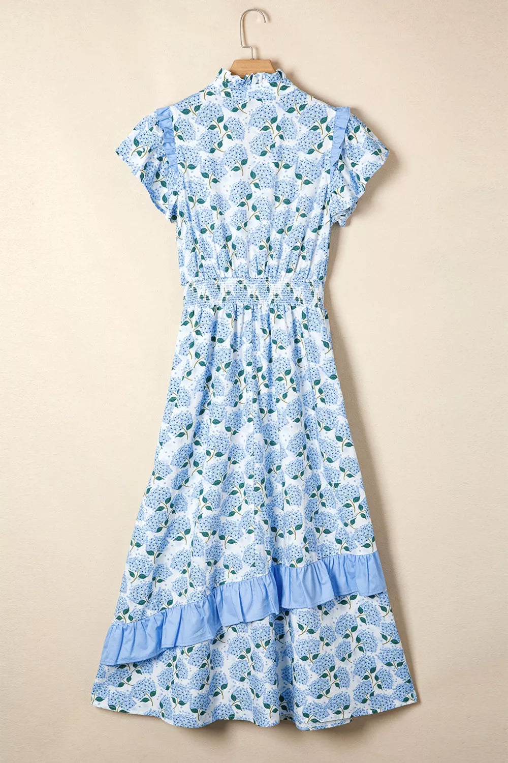 Blue floral dress on a beige background
