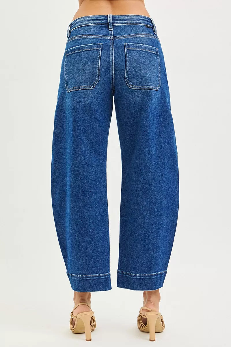 Blue jeans worn by a person on a white background