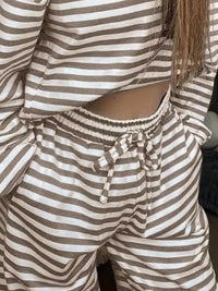 Person wearing a brown and white striped outfit with a cut-out design.