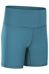 Teal athletic shorts on a white background