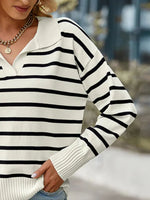 Person wearing a black and white striped sweater with a blurred background