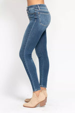 Blue jeans worn by a person on a white background