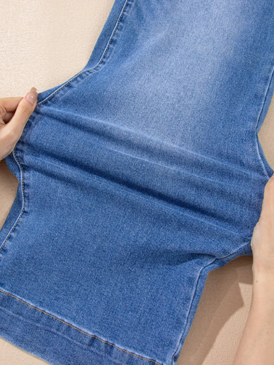 Close-up of blue denim fabric with a beige background