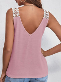 Pink tank top with lace straps worn by a person on a white background