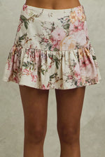 Floral skirt worn by a person on a neutral background