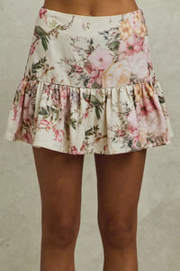 Floral skirt worn by a person on a neutral background
