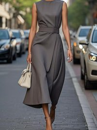 Woman in a gray dress walking on a city street