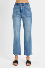 Blue jeans worn by a person on a white background