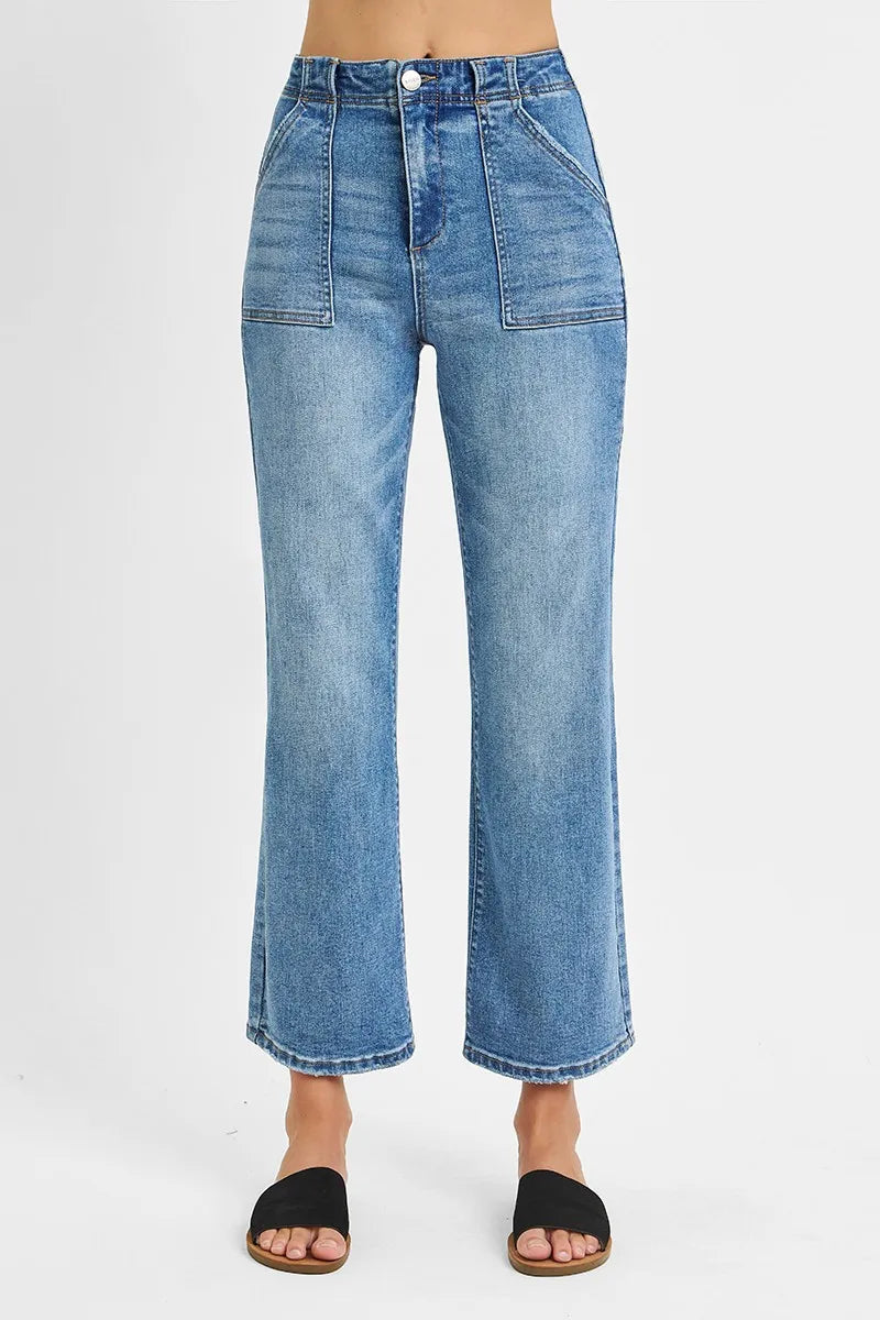 Blue jeans worn by a person on a white background